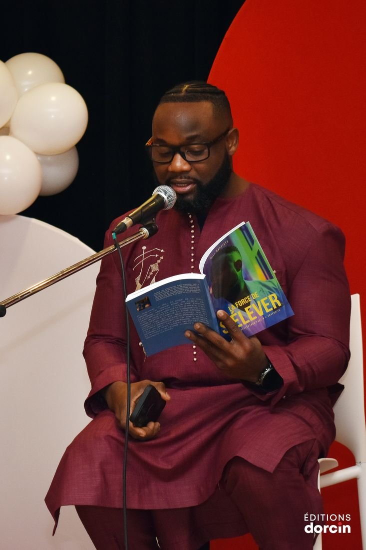 A guest author reading an excerpt from their book at the microphone